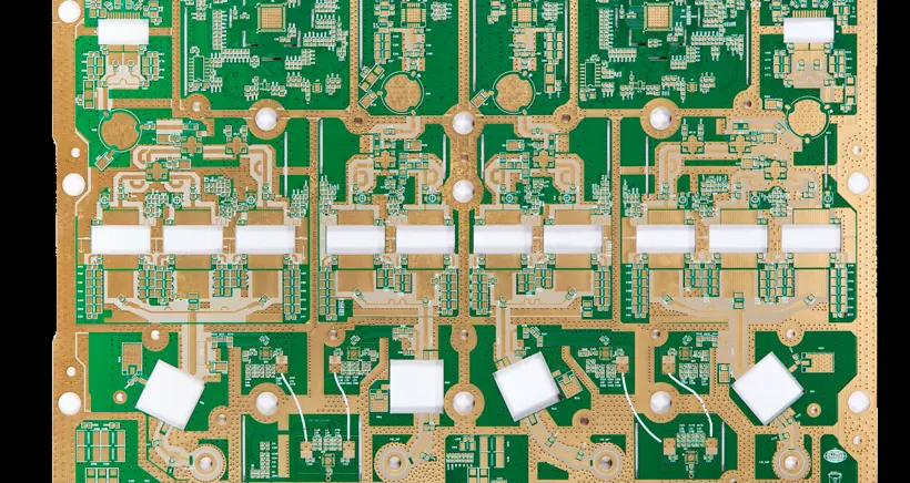 Panel of printed circuit boards with green solder mask, exposed copper and routed openings